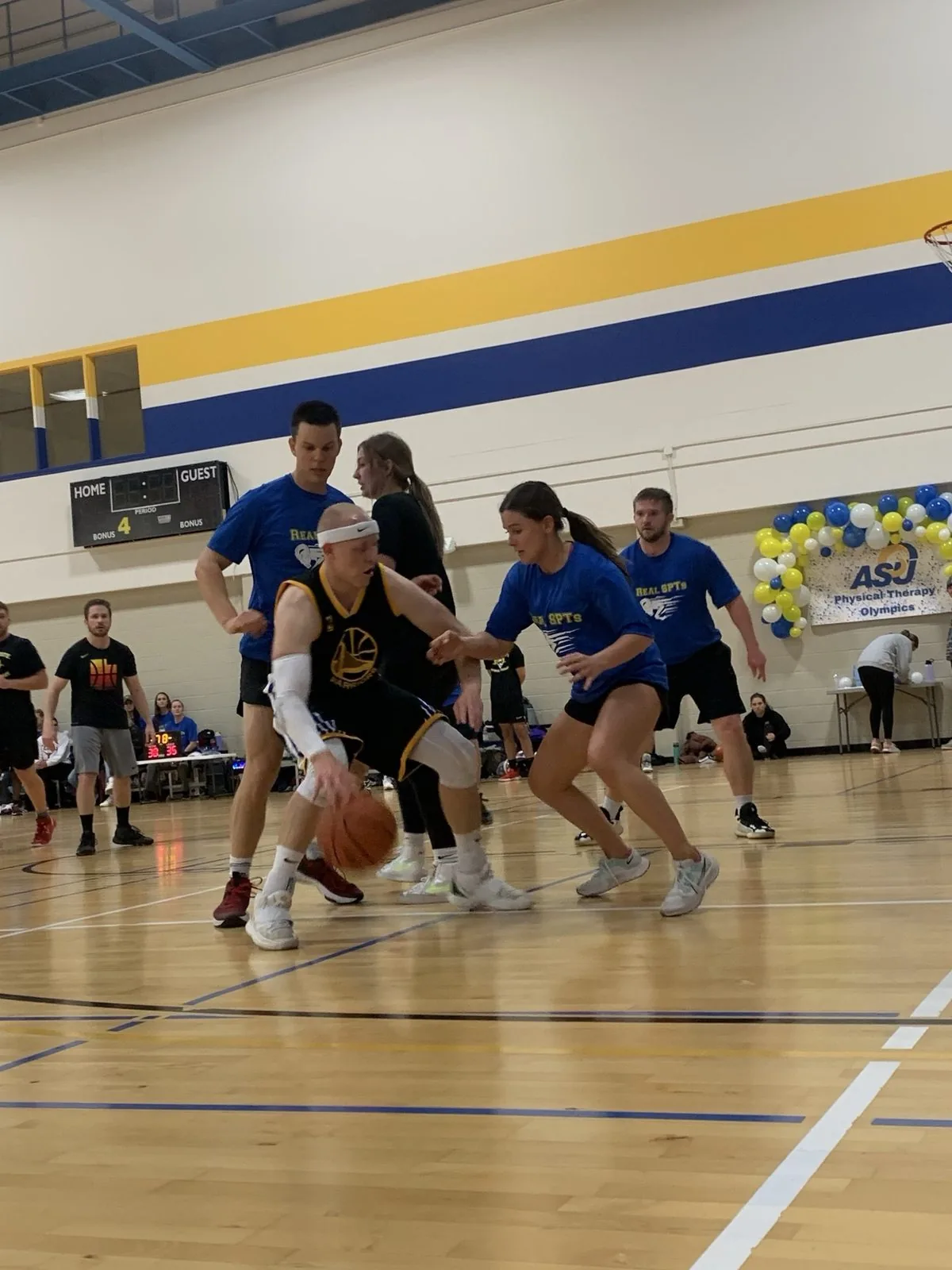 Dr. Ben Graves, physical therapist, driving to the basket during a department game