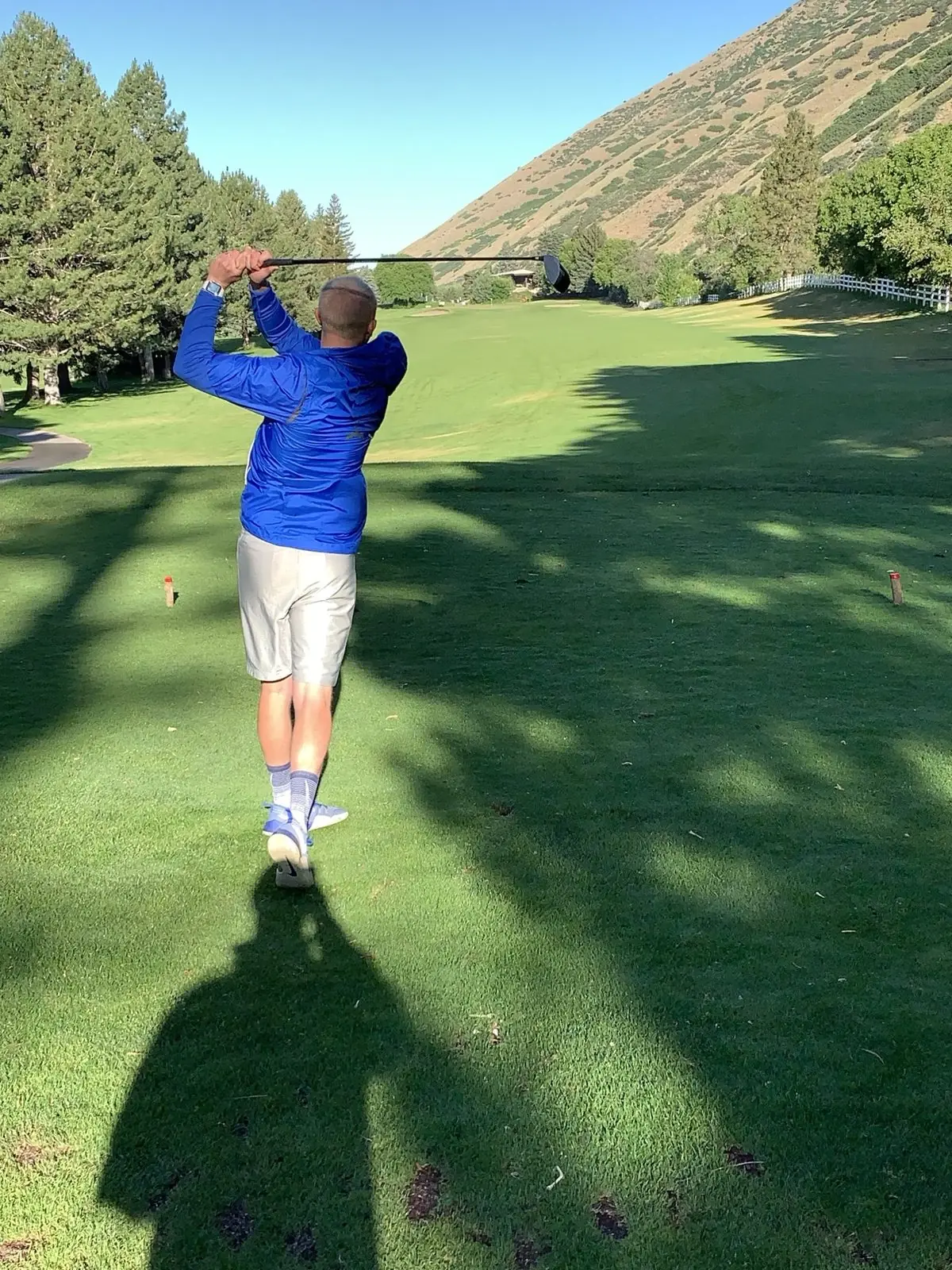 Dr. Ben Graves, physical therapist, swinging a driver on a golf course